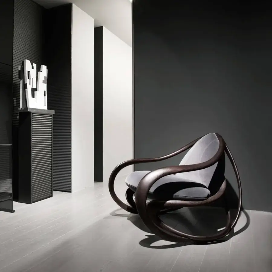 Elegant Giorgetti Move lounge chair crafted with dark-finished solid ash wood and upholstered in refined gray textiles