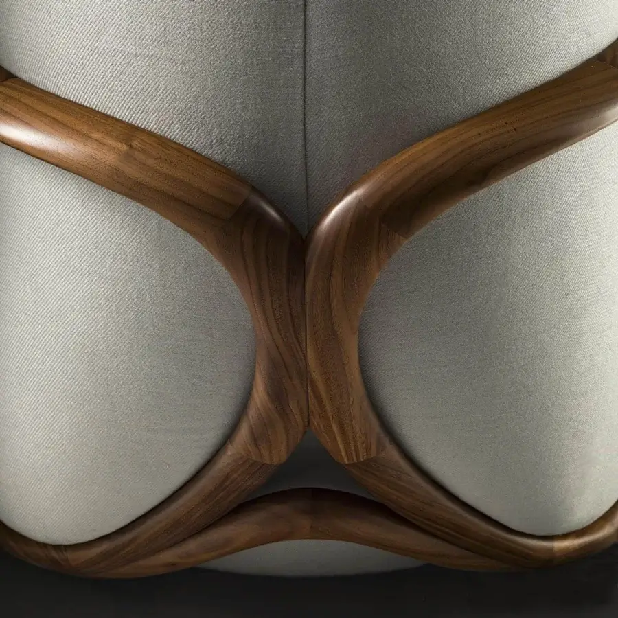 Lavish Giorgetti Hug lounge chair with light gray textile upholstery and a glossy canaletto walnut framework