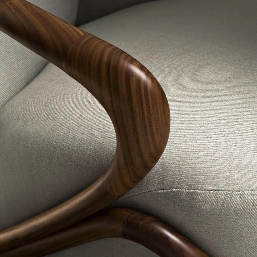 Distinguished Giorgetti Hug lounge chair with light gray upholstery and a glossy canaletto walnut load-bearing structure