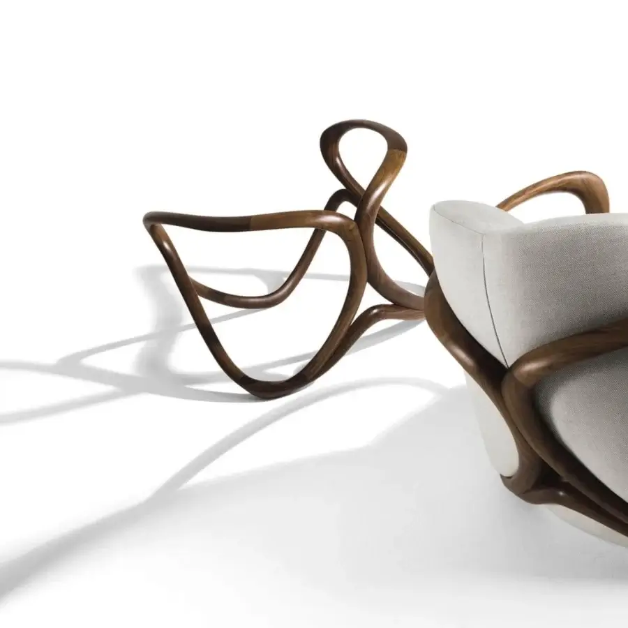 Exclusive Giorgetti Hug lounge chair with softly shaped light neutral upholstery and a meticulous canaletto walnut frame