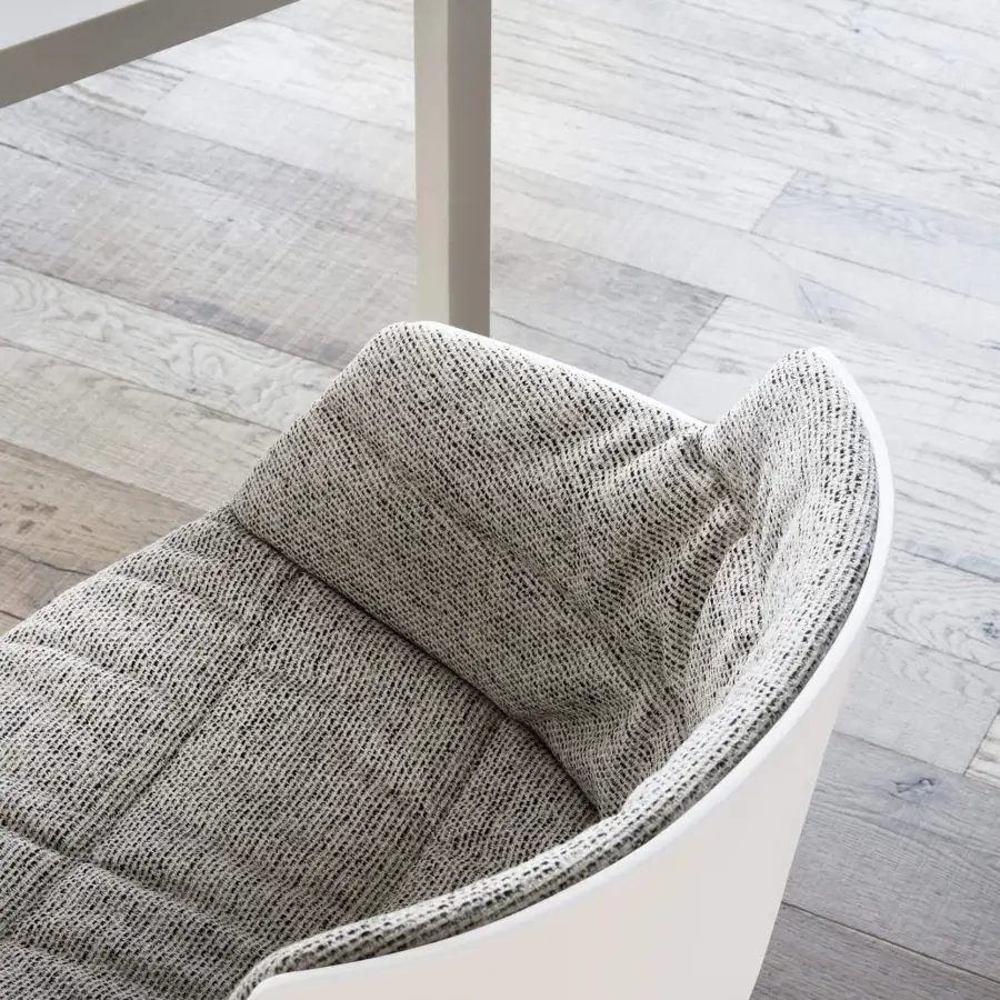 Elegant MDF Italia Flow armchair with curved form, white shell and black woven textile upholstery with quilted detail, epoxy powder coated aluminum base