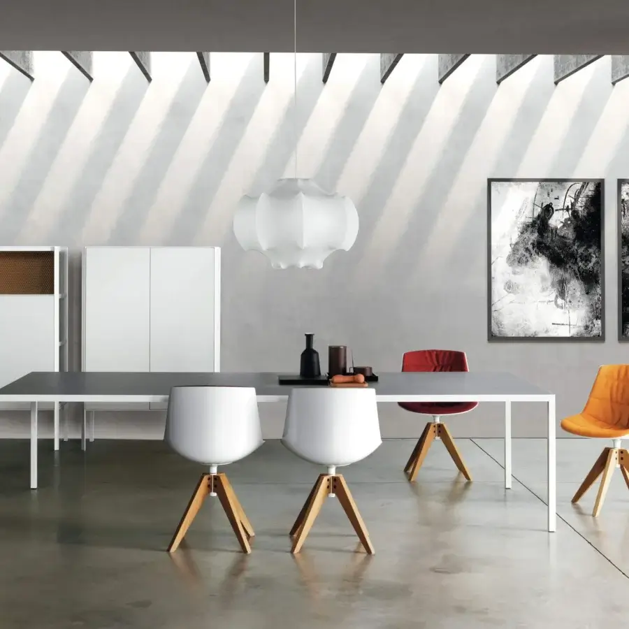 Elegant MDF Italia Flow chair with matte white shell, vibrant orange fabric upholstery and light-toned wooden tripod base with swivel function