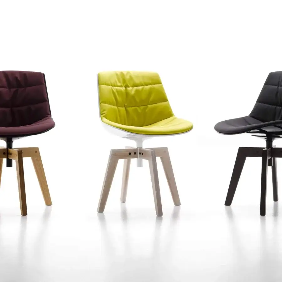 Distinguished MDF Italia Flow chair with inviting curved seat and quilted yellow textile upholstery in a satin light-toned wooden base