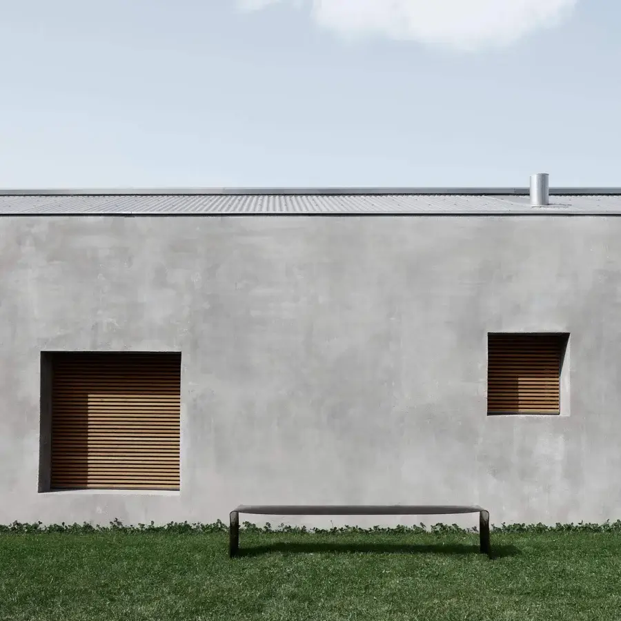 Elegant MDF Italia Le Banc bench crafted with a single curved sheet of aluminum in a dark matte finish