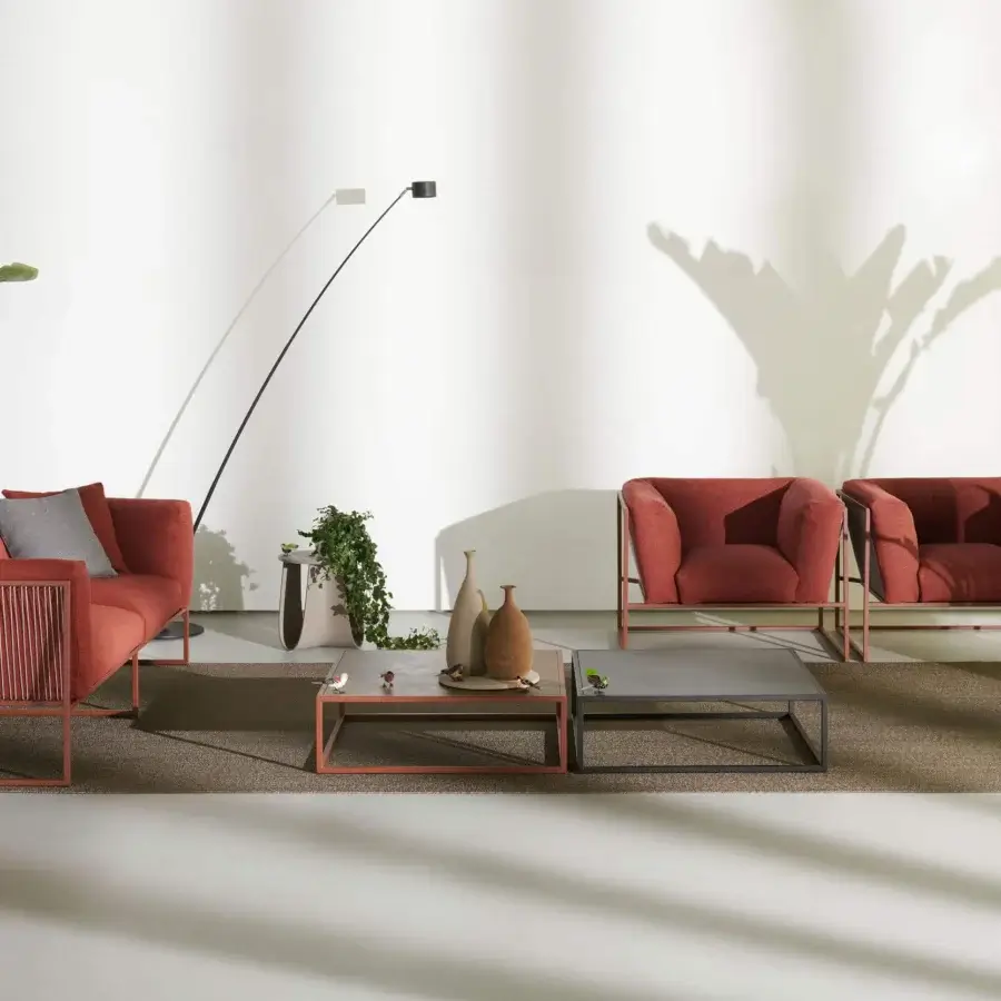 Superior MDF Italia Arpa lounge chair with reddish-brown cushions suspended in corten epoxy powder coated stainless steel and woven cord backrest