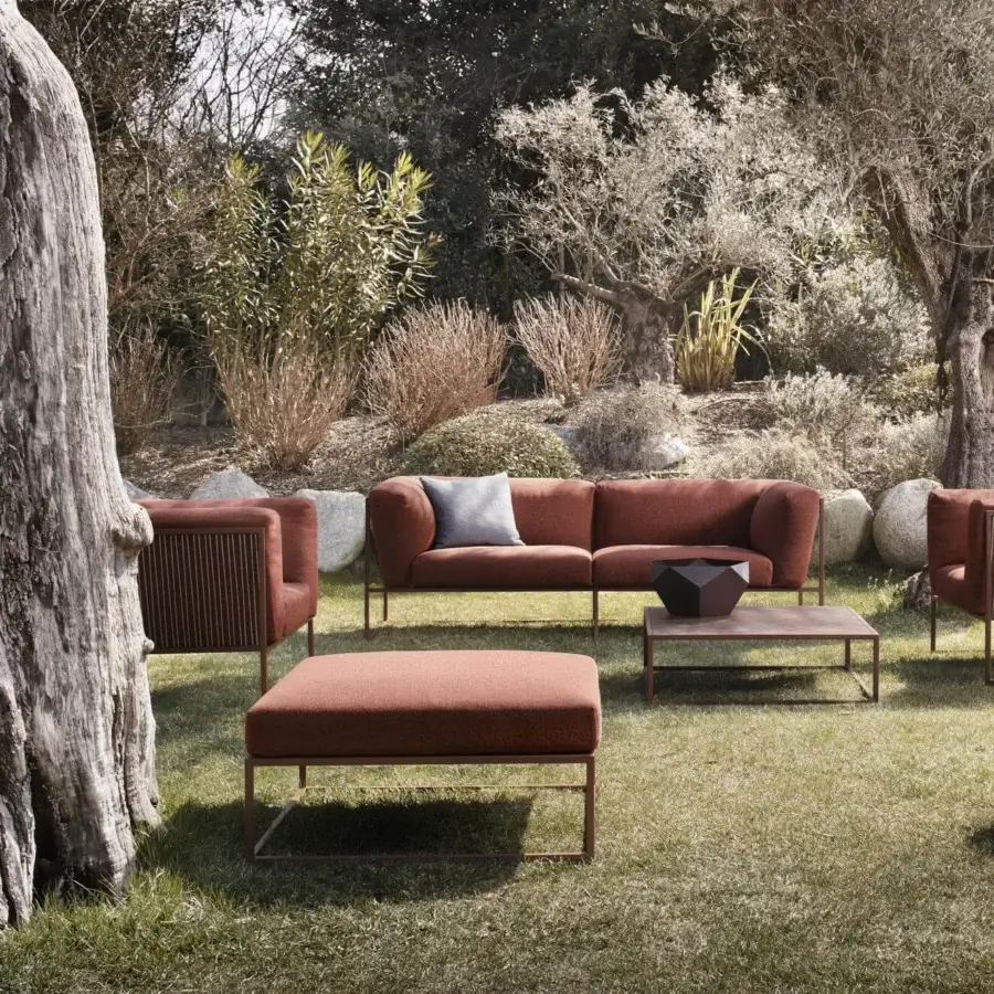 Elegant MDF Italia Arpa lounge chair upholstered in terracotta Tecno Strong fabric with stainless steel and corten epoxy powder coated finish