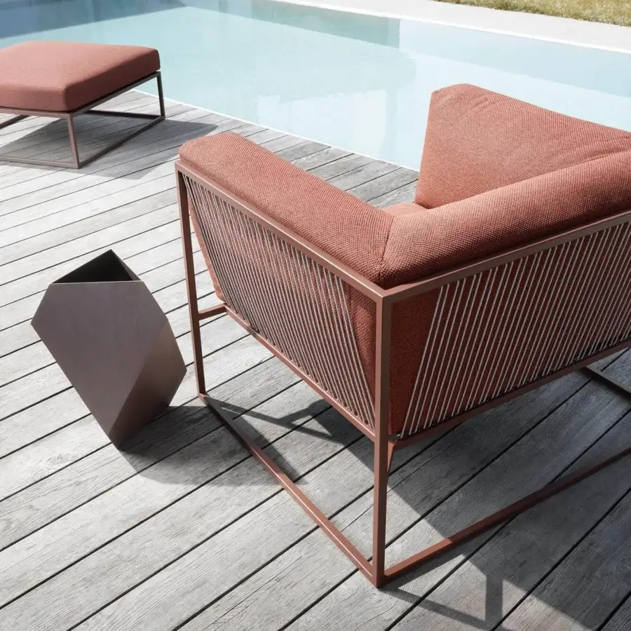 Distinguished MDF Italia Arpa lounge chair with stainless steel frame, reddish-brown textured cushions and handwoven polyester cord backrest