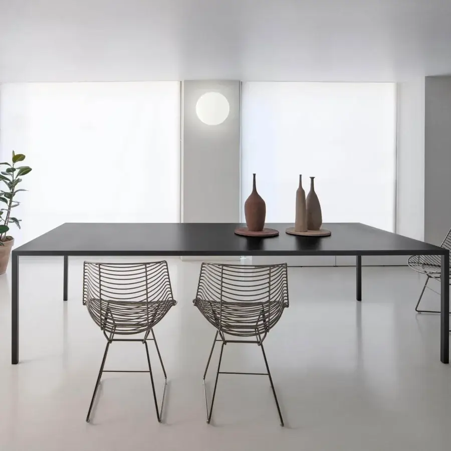 Exclusive MDF Italia Flow Filo chair crafted with curvilinear steel rods in matt bronze finish exhibiting a minimalist aesthetic