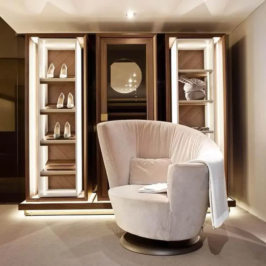 Exceptional Giorgetti Arabella lounge chair upholstered in light beige textile with smooth matte finish and bronze metal swivel base