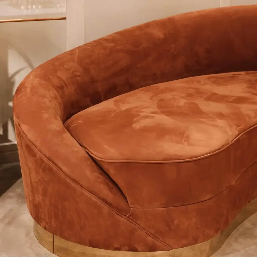 Exclusive Vismara Wavy sofa with sinuous shapes upholstered in orange-brown textile and matte finish plated steel base