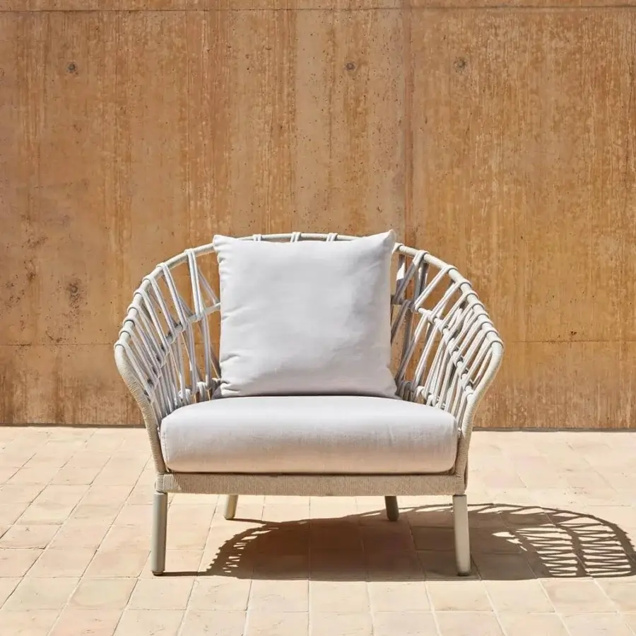 Sophisticated Varaschin Emma Cross lounge chair with light gray cushions and woven acrylic fabric in a powder-coated aluminum frame