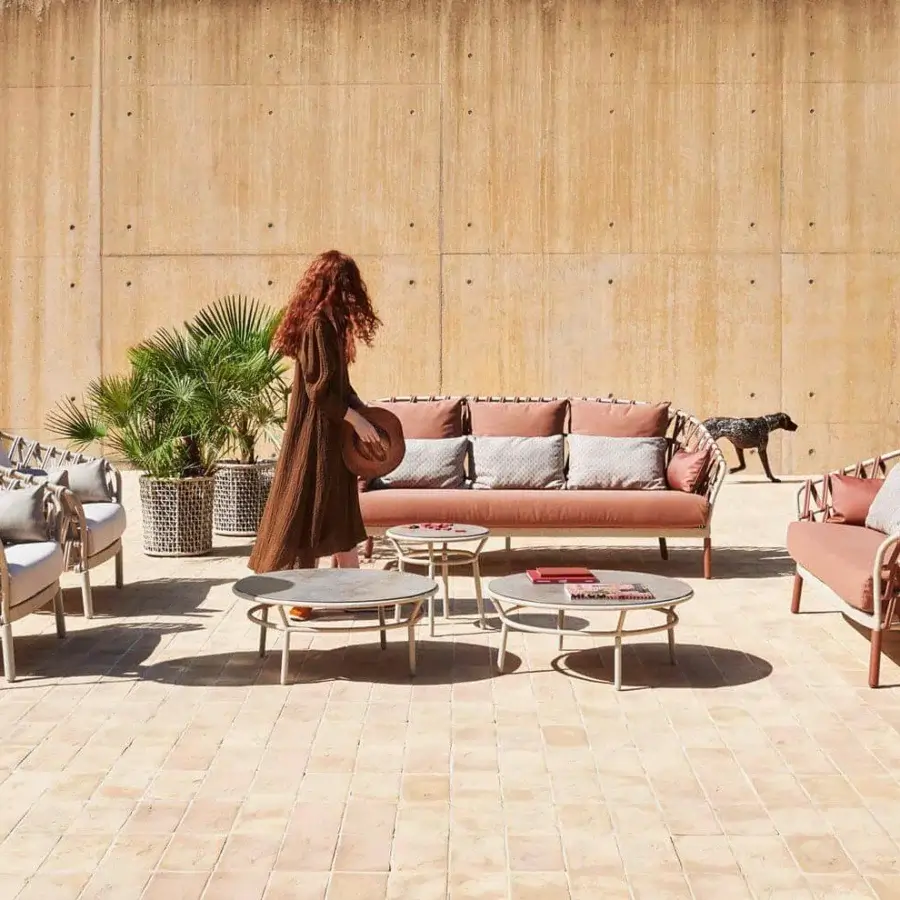 Lavish Varaschin Emma Cross lounge chair with woven acrylic band and light red-brown powder-coated aluminum frame