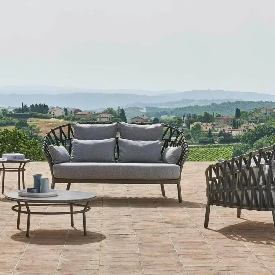 Elegant Varaschin Emma Cross sofa with dark woven fiber, light gray cushions and powder-coated aluminum frame