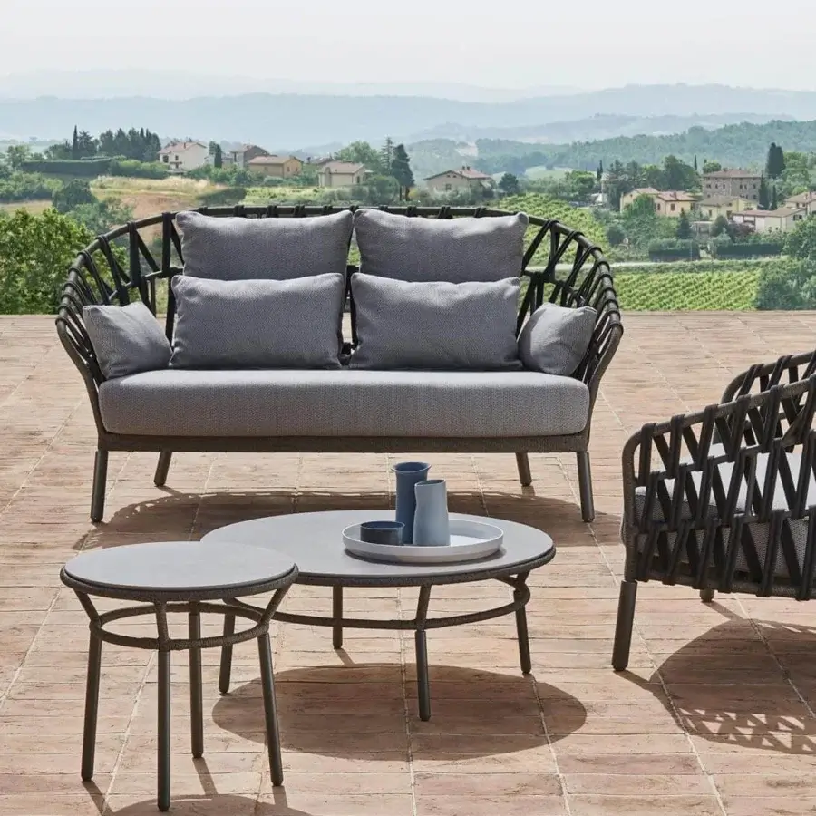 Distinguished Varaschin Emma Cross sofa with dark hand-woven acrylic Band fabric and woven gray cushions, built with a powder-coated aluminum frame