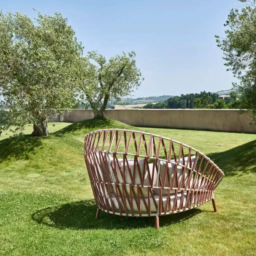 Lavish Varaschin Emma Cross daybed with handwoven acrylic Band fabric and light gray cushions on a powder-coated aluminum frame