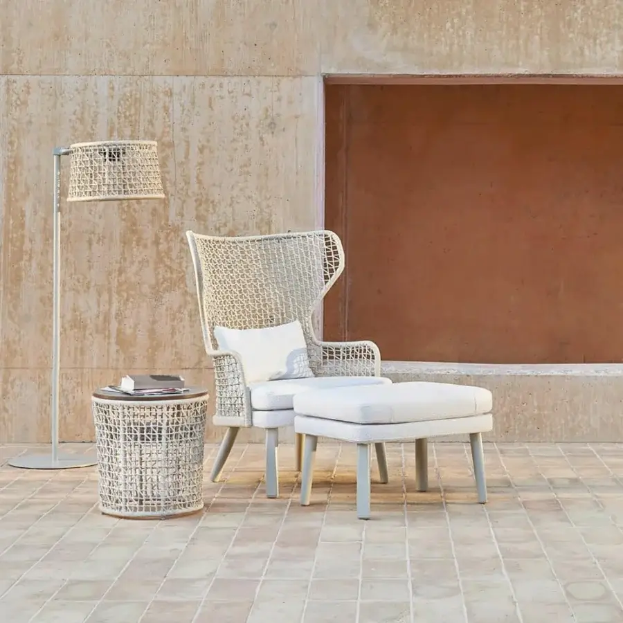 Elegant Varaschin Emma side table with light beige woven base and bush-hammered ceramic top crafted with powder-coated aluminum