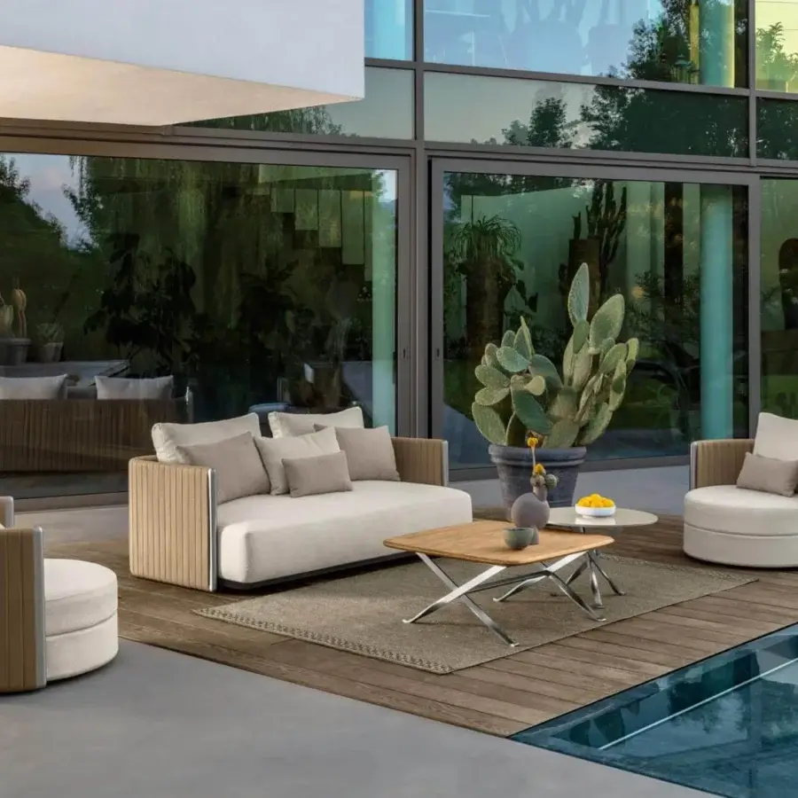 Distinguished Talenti George sofa with a stainless steel structure and light brown rope weave, complemented by light beige textile cushions
