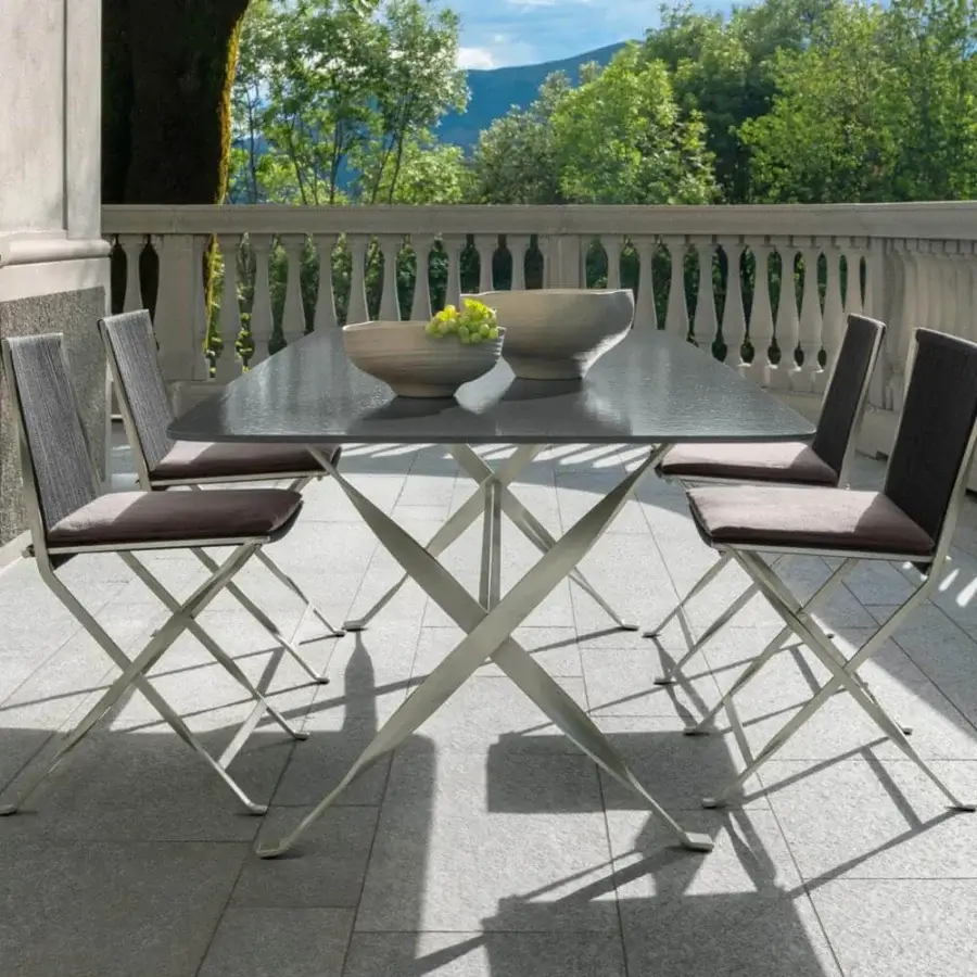 Superior Talenti George table with a square dark gray lava stone top and geometric stainless steel base