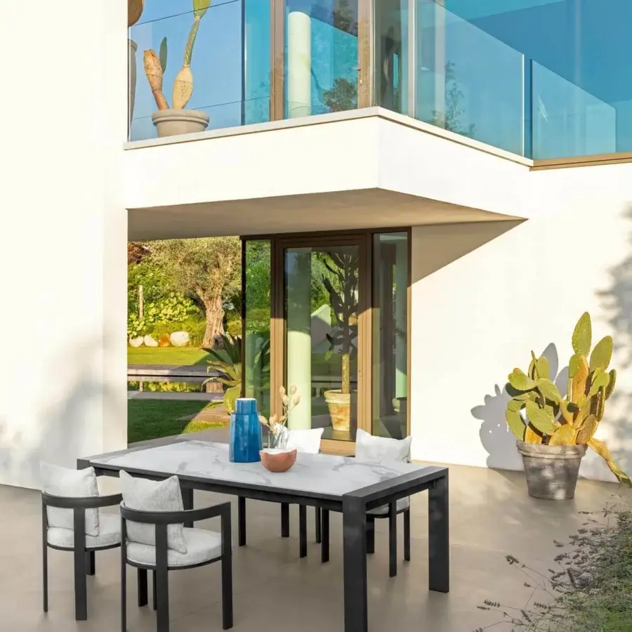Distinguished Talenti Argo Alu table with dark powder-coated aluminum and refined calacatta porcelain stoneware tabletop