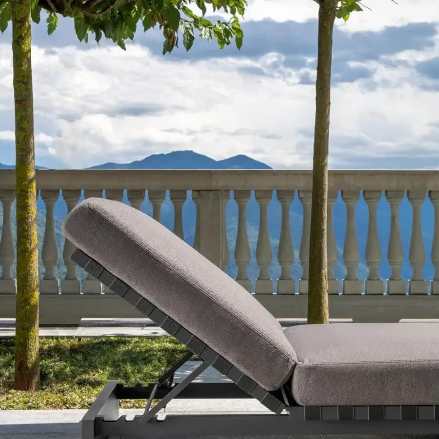 Distinguished Talenti Argo Alu lounger with comfortable padded cushions and a woven synthetic elastic strap seat in medium gray aluminum