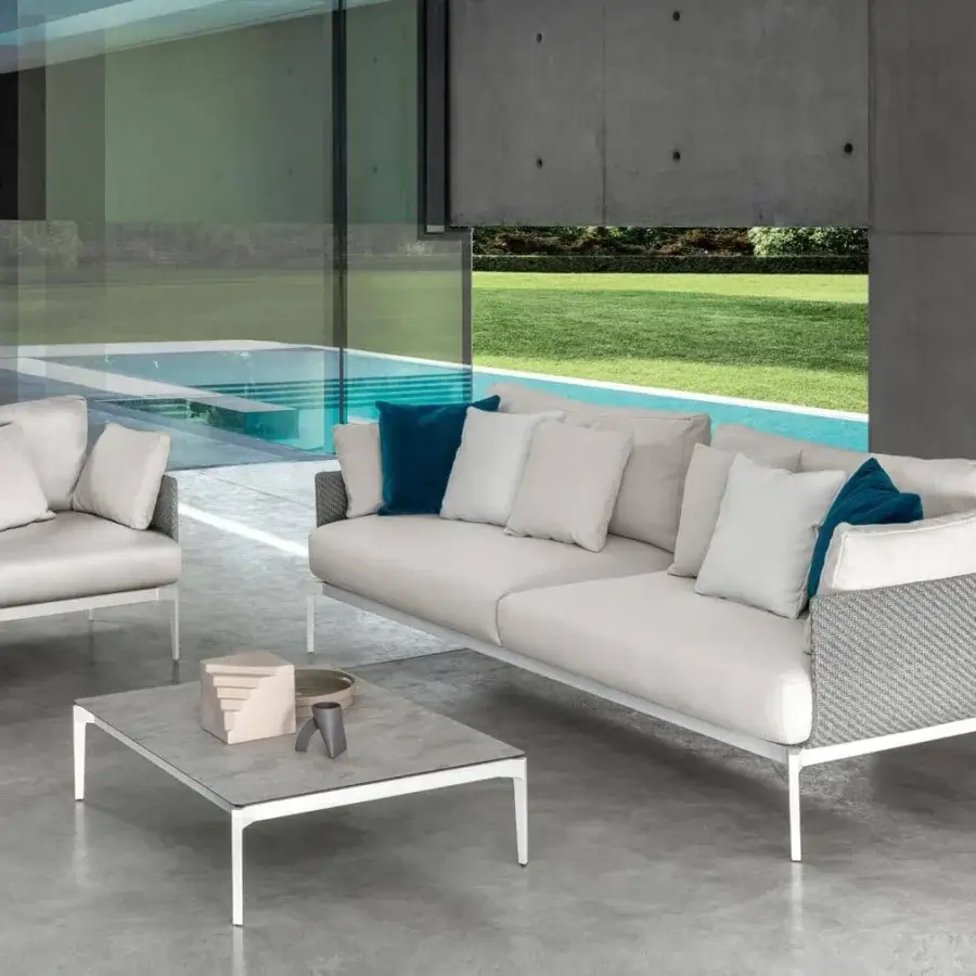 Distinguished Talenti Leaf lounge chair with light aluminum structure and dark blue cushion in light gray matte textile