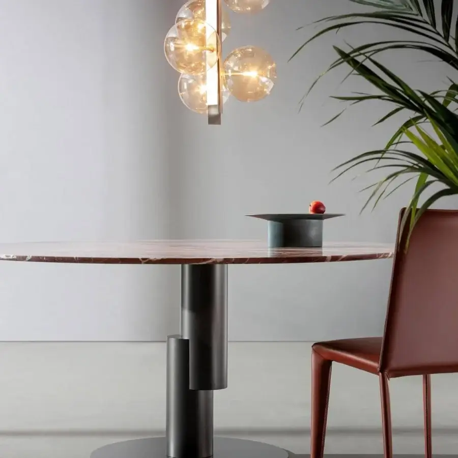Distinctive Bonaldo Innesti table with a composite marbled tabletop in brown, pink and cream shades and dark matte cylindrical metal base