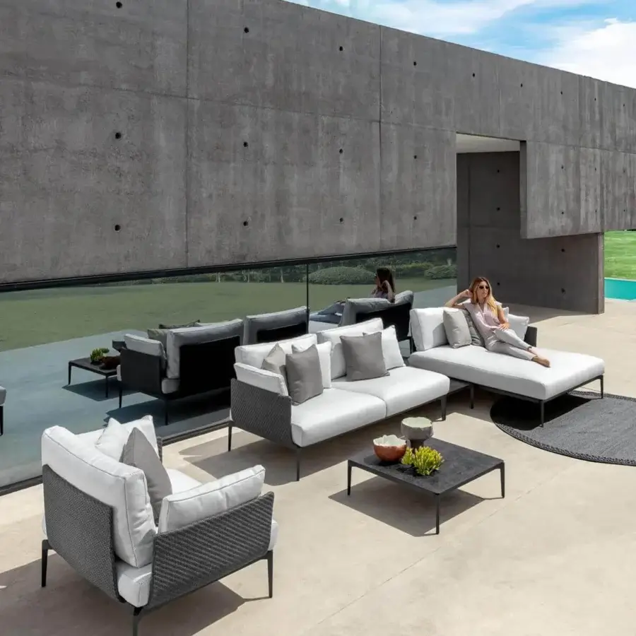Exceptional Talenti Leaf sectional with dark aluminum frame, light gray textile cushions and a woven synthetic material construction