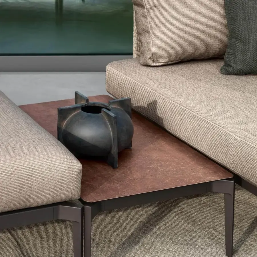 Superior Talenti Leaf sectional with woven beige cushions and a dark metal aluminum structure