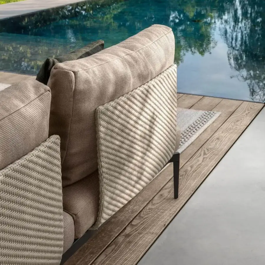Elegant Talenti Leaf sectional with light beige woven cushions and a dark aluminum frame