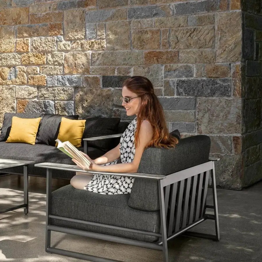 Exceptional Talenti Riviera lounge chair with light gray aluminum and dark gray textile cushions with stoneware armrests