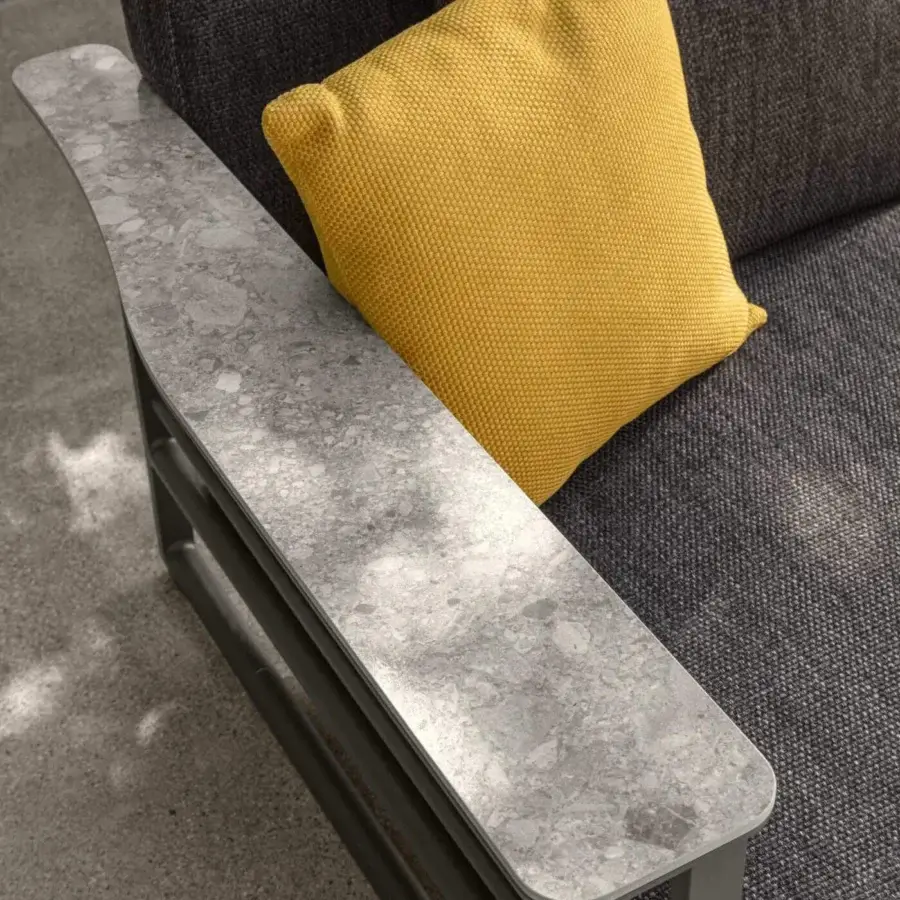 Superior Talenti Riviera sofa with dark gray woven textile upholstery and bright yellow cushion accents against gray stoneware armrests