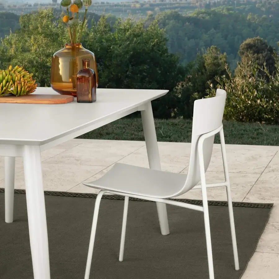 Exceptional Talenti Malè chair with curved form in smooth matte white polyurethane and solid steel construction