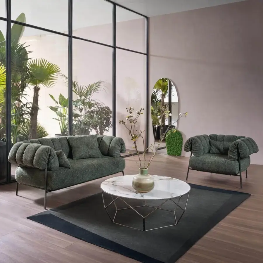 Sophisticated Bonaldo Tirella lounge chair with muted green textured textile and dark metal enveloping cushions