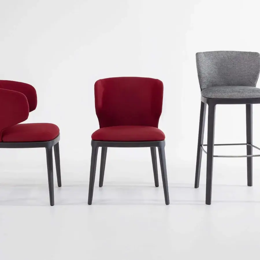 Exclusive Bonaldo Joy chair with solid wood base and vibrant red textile upholstery alongside a grey variant