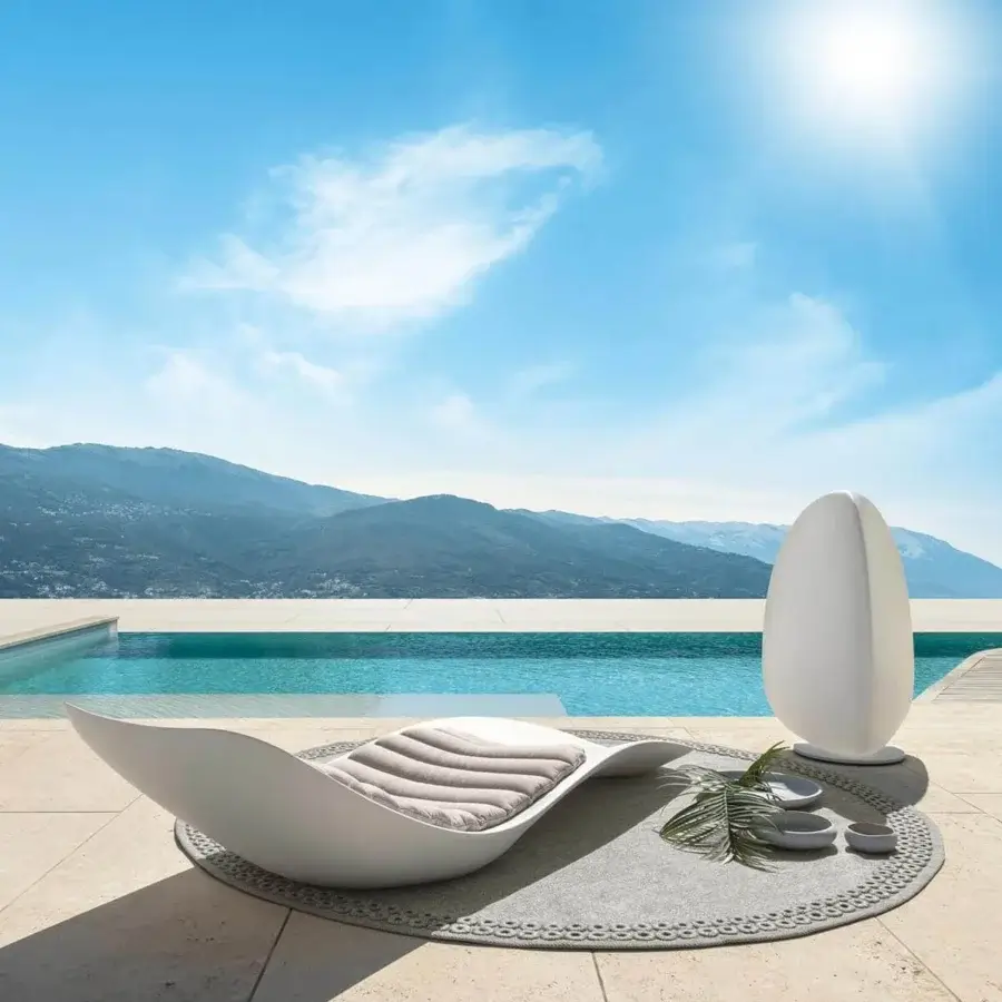 Elegant Talenti Reef lounger crafted in white plastic with a tufted gray cushion and balanced form