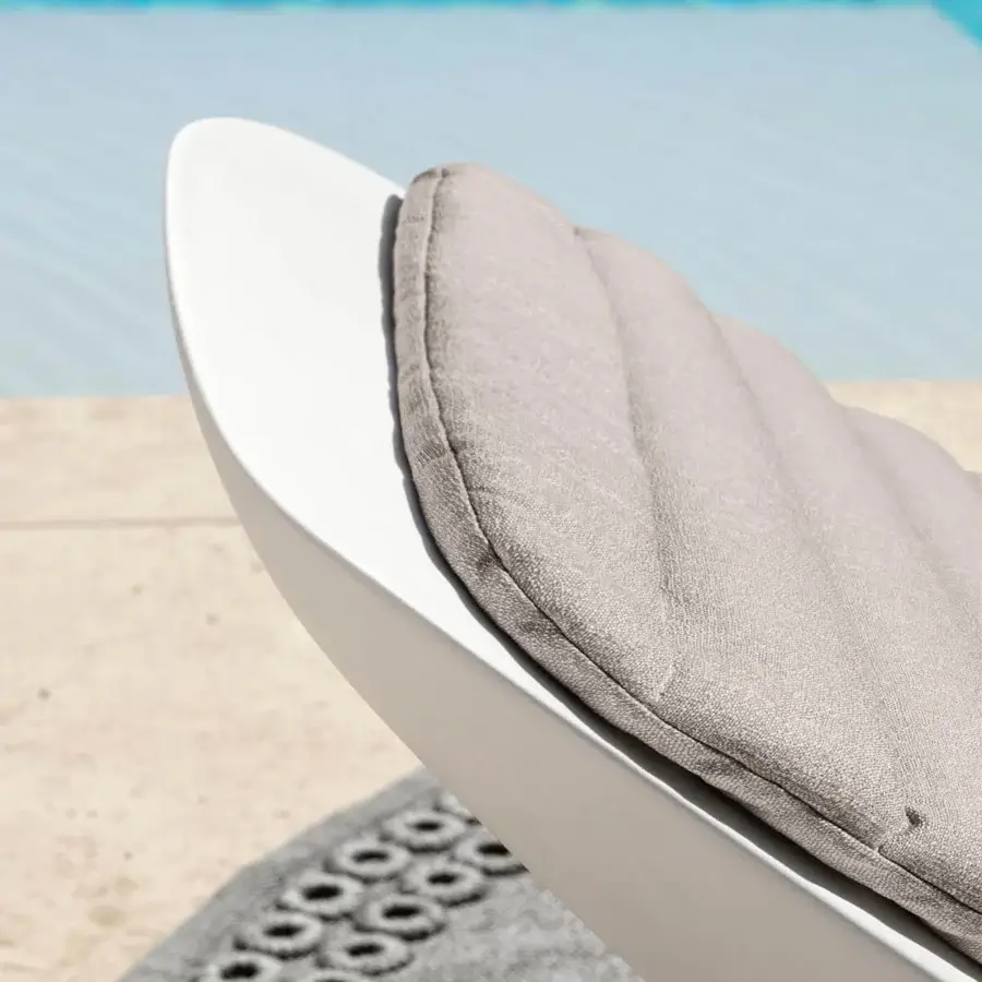Distinguished Talenti Reef lounger crafted in durable white plastic with a smooth finish and quilted grey textile cushion