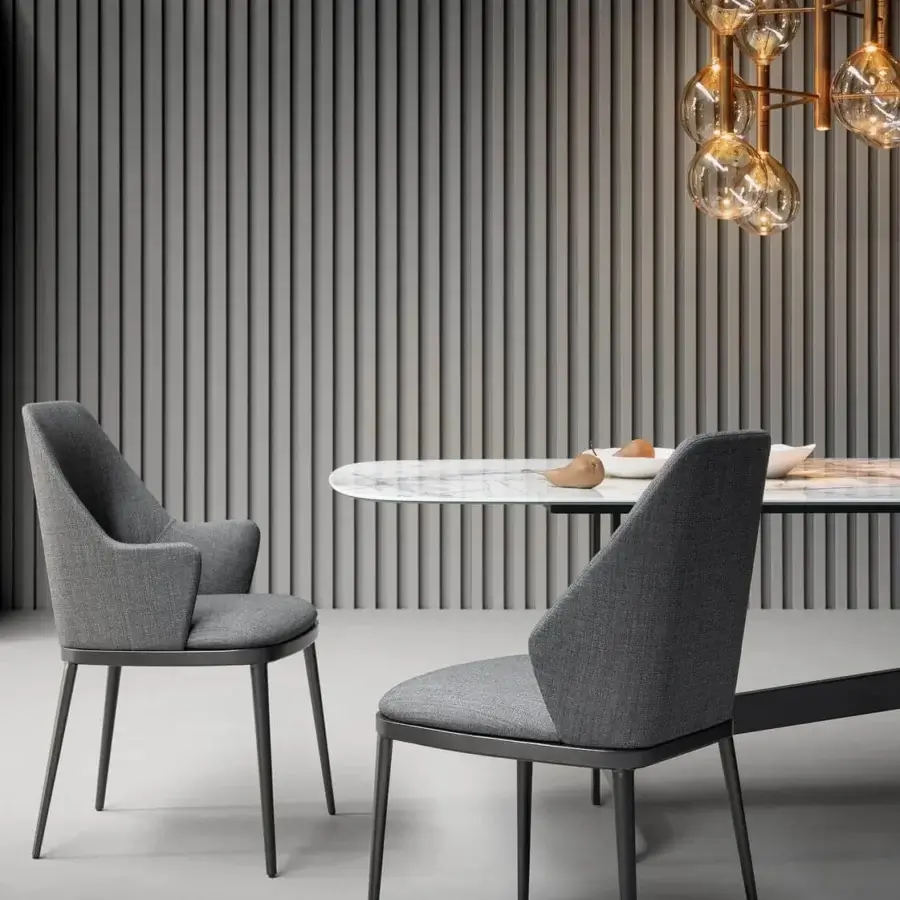 Sophisticated Bonaldo Mida chair in medium gray fabric exhibits a harmonious design with slender metal legs and enveloping backrest