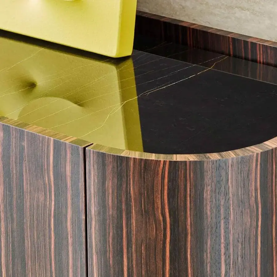 Superior Rugiano Frak sideboard with ebony structure, golden-veined reflective top, and stylish brass feet