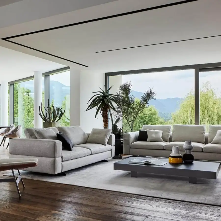 Sophisticated Bonaldo Ever More sofa with light grey matte textile upholstery and dark grey cushions built with sleek matt-painted metal feet