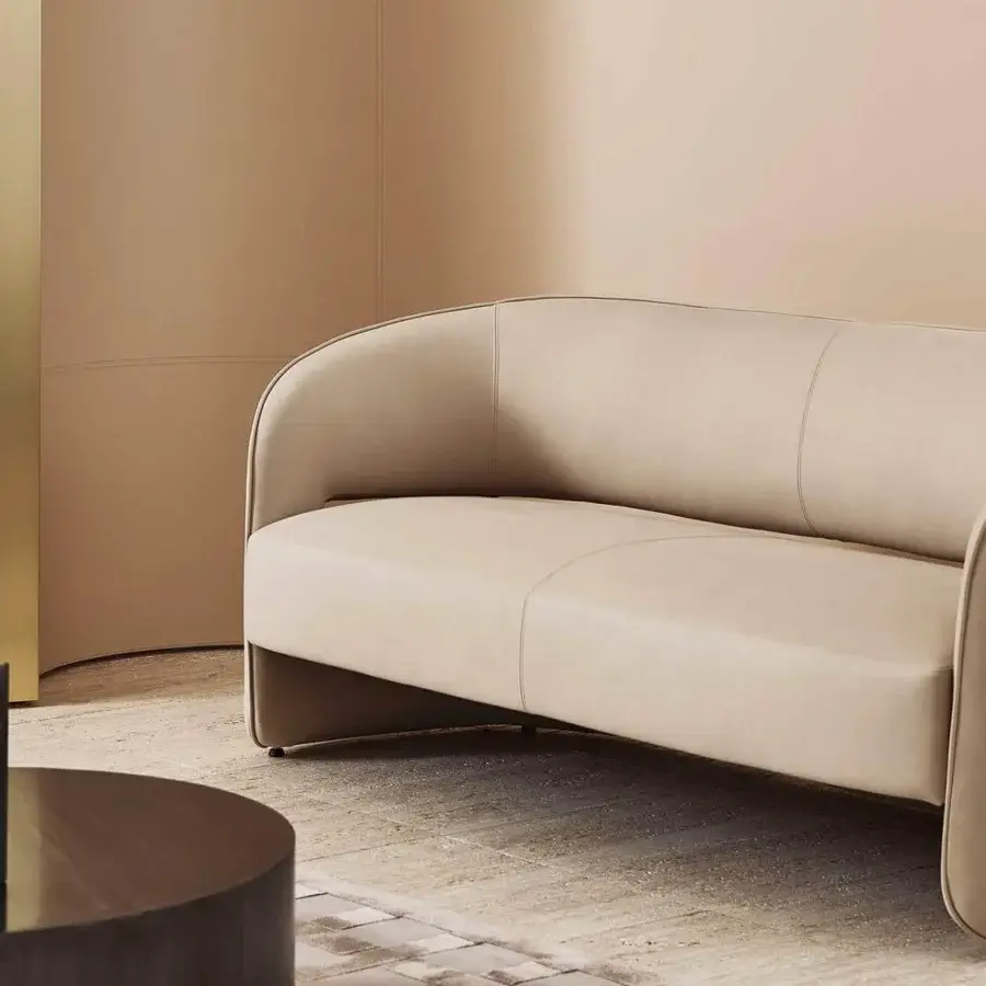 Elegant Rugiano Ambra sofa with refined curved silhouette upholstered in smooth beige high-end fabric