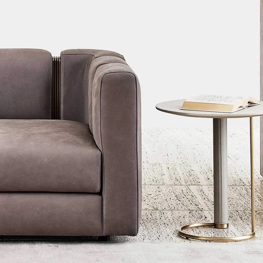 Elegant Rugiano Opale side table with cylindrical medium gray textured leather leg and brushed brass base supporting a matte light gray marble top