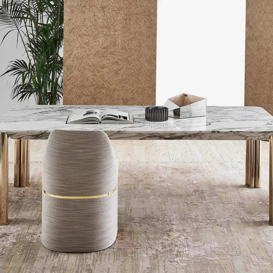 Elegant Rugiano Giorgia armchair with unified backrest and base, refined gold-colored metal detail, light neutral woven textile upholstery, matte finish