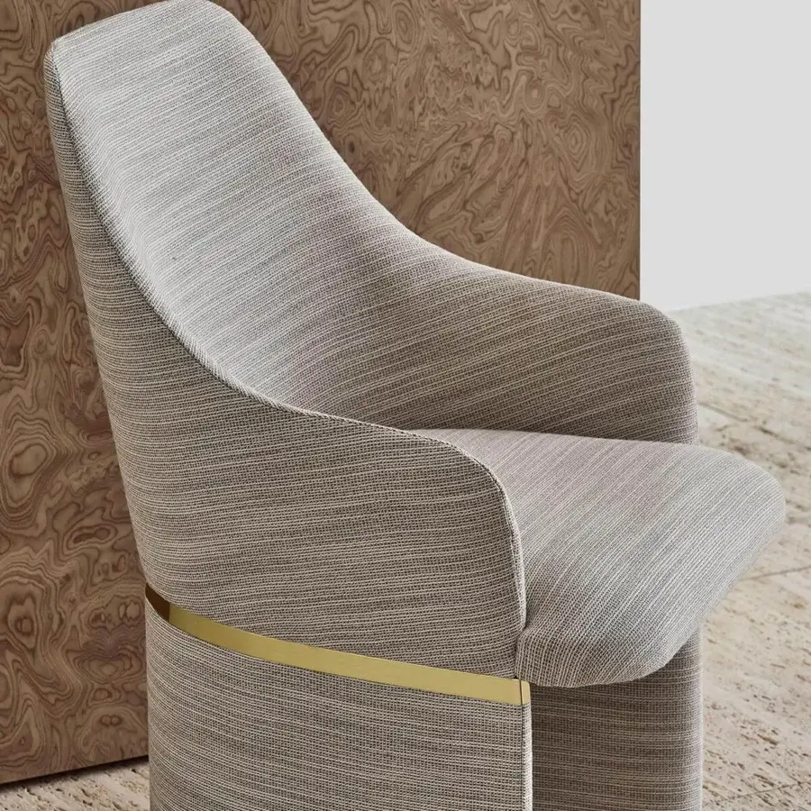 Superior Rugiano Giorgia armchair with curved form and woven light to medium tone textile upholstery with golden metallic accentuation