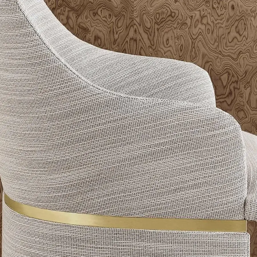 Distinguished Rugiano Giorgia armchair with curved silhouette and light gray woven textile upholstery with gold-colored metal detail