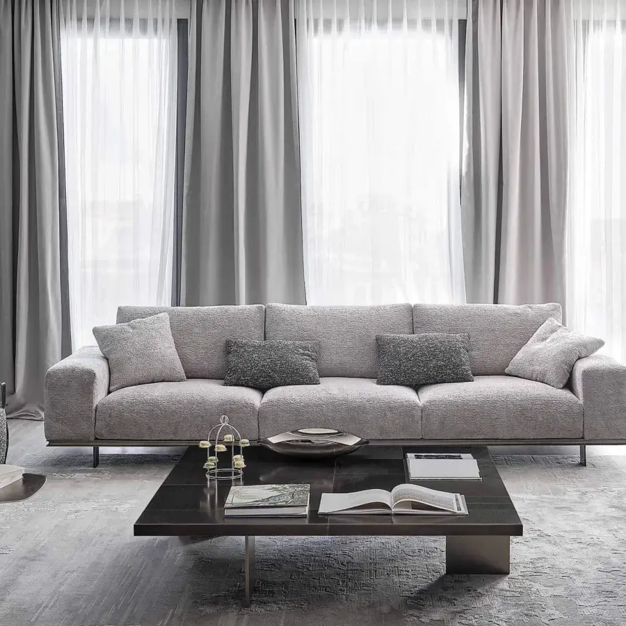Elegant Rugiano Memphis sofa with neutral gray woven fabric upholstery, darker gray cushions and a linear metal base