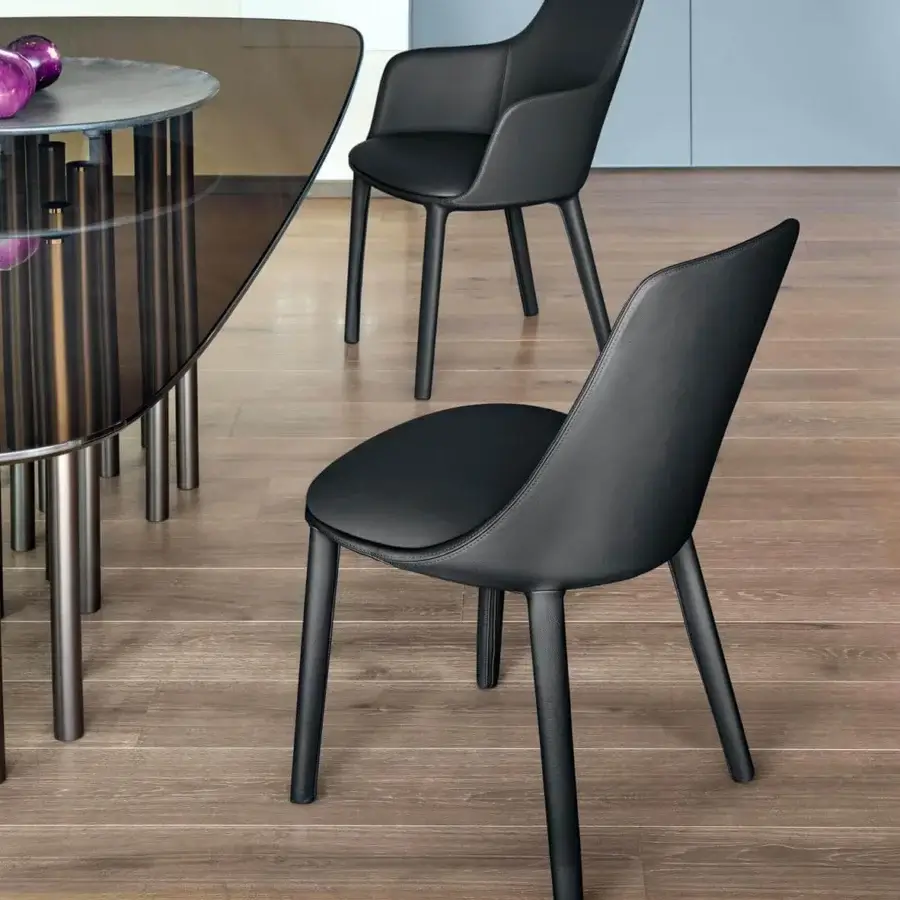 Distinctive Bonaldo Itala chair with fully upholstered seat and backrest in sleek dark material and visually light metal legs