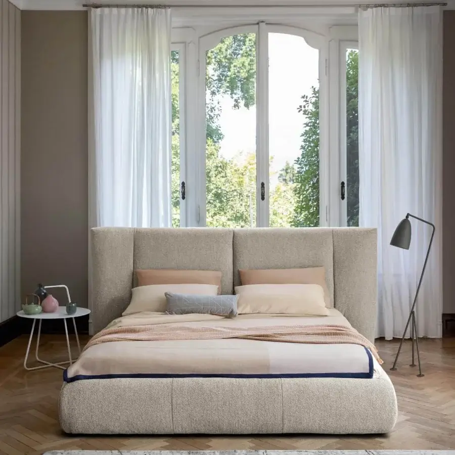 Distinguished Bonaldo Youniverse bed with large padded headboard delicately folded inward in neutral beige textile upholstery