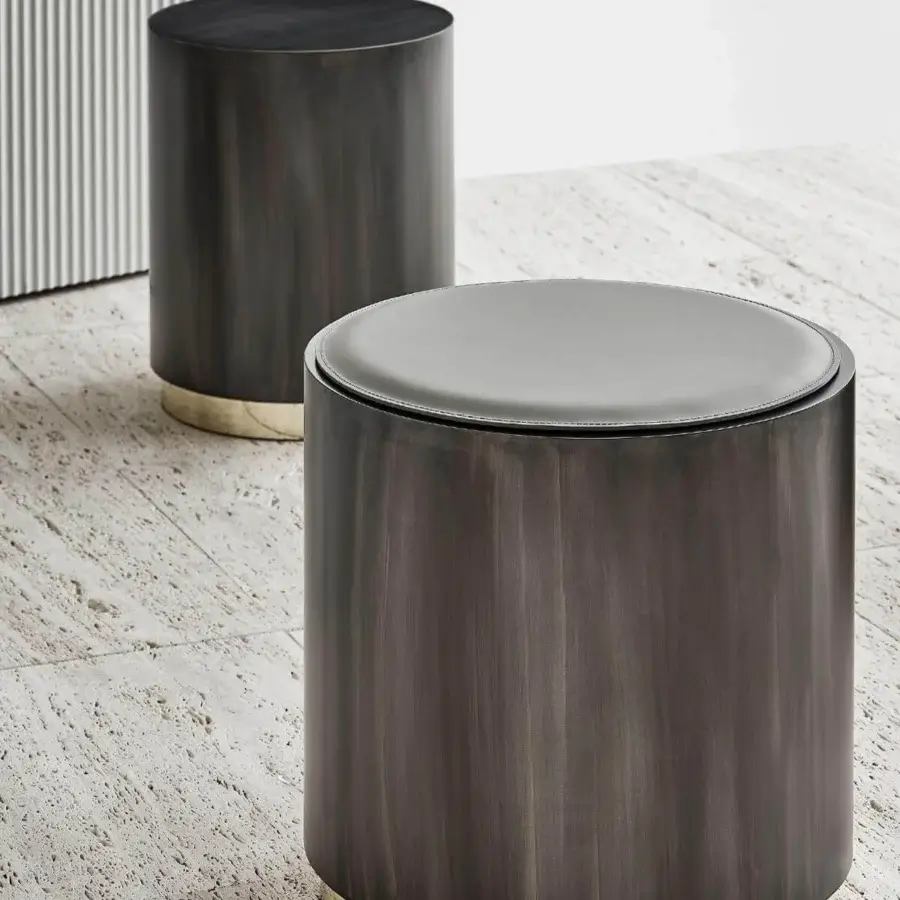 Superior Rugiano Genesi side table in flamed iron with glossy gold details and smooth gray cushion
