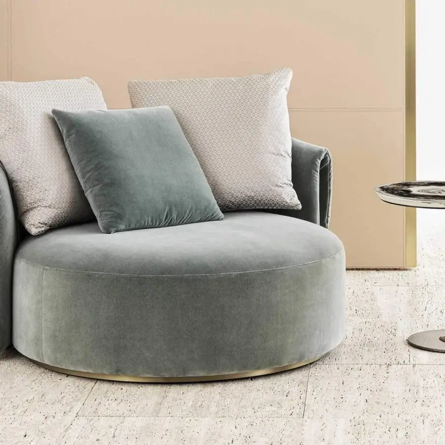 Elegant Rugiano Manta chaise lounge crafted in grayish-green textile with bronze plinth base and decorative pillows
