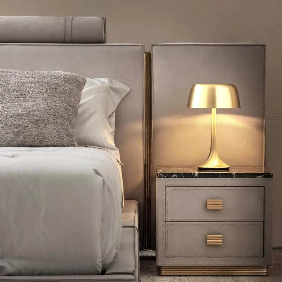 Exclusive Rugiano Rubik nightstand upholstered in light grey leather with a luxury marble top and gold-toned brass details, exhibiting a smooth matte finish
